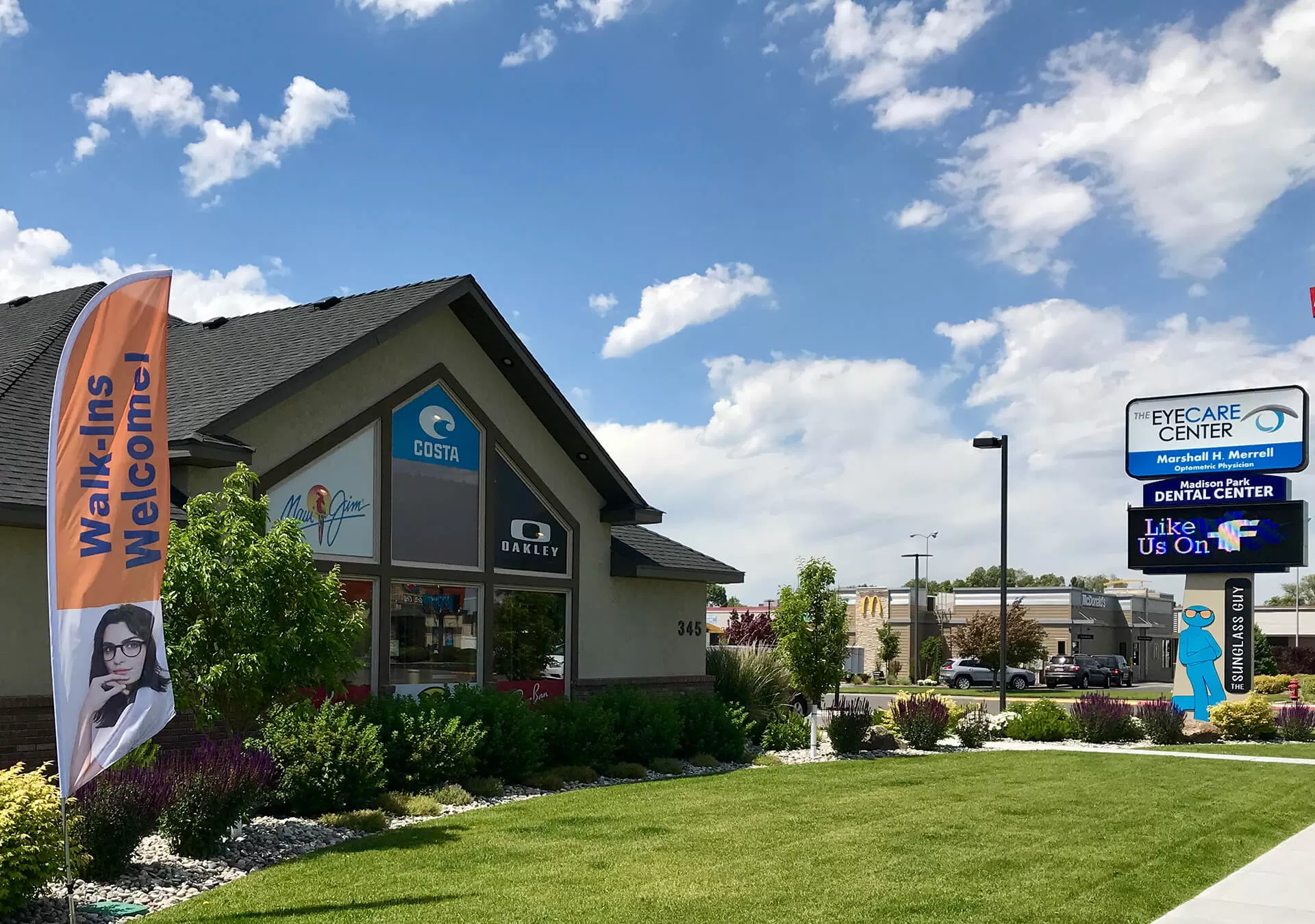 The Eyecare Center Rexburg office, a stucco building at 345 North 2nd East with Costa, Maui Jim and Oakley window signs.